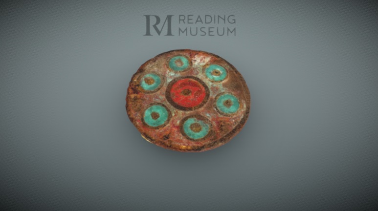 brass brooch with red and green enamel