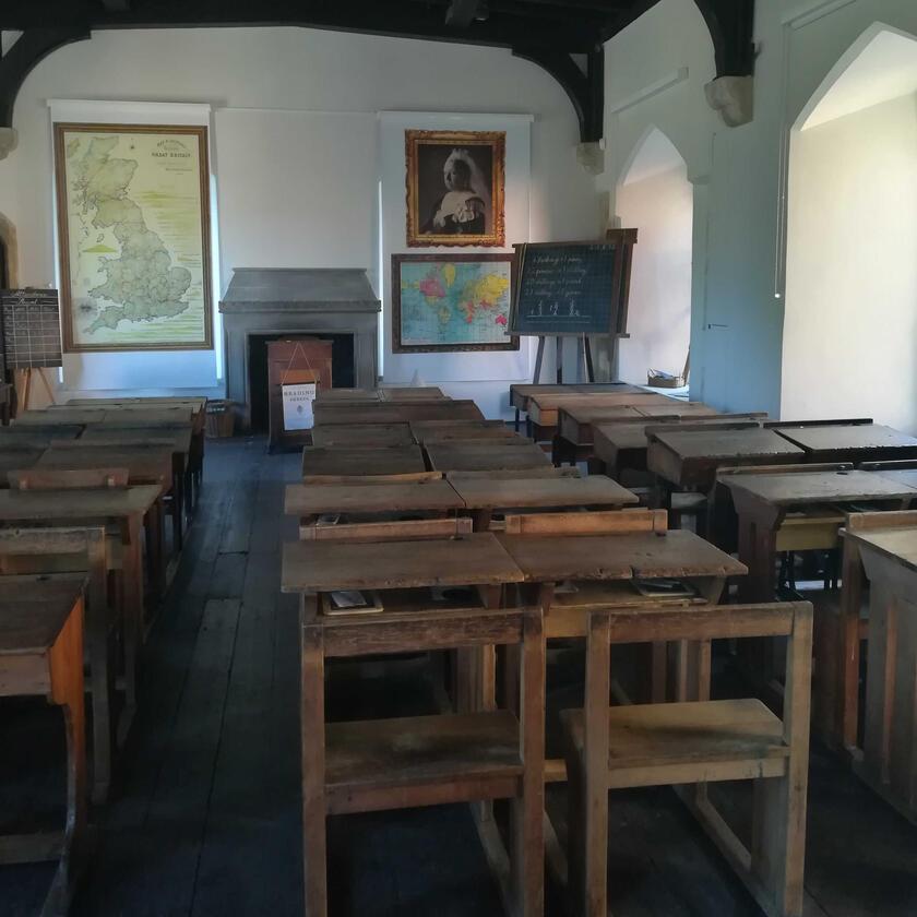 a view of the mock Victorian Schoolroom with rows of old desks