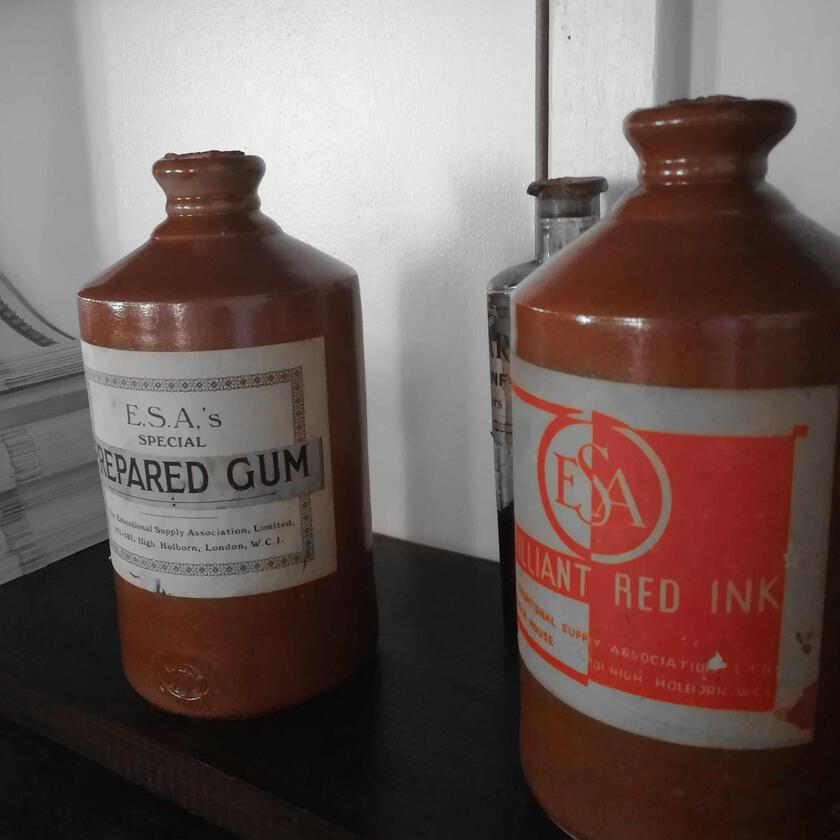 two old ink bottles on a desk